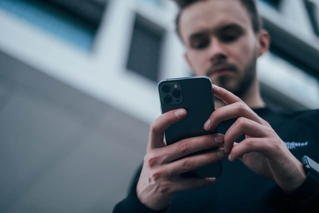 A man reading reviews on a phone